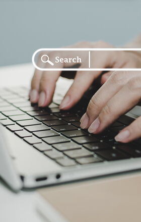 Eine Person tippt auf einem laptop, über dem Foto eingeblendet sieht man die Darstellung einer Suchfunktion einer Suchmaschine.